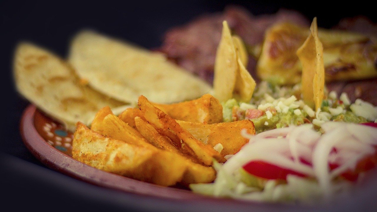 Crispy golden sheet-pan quesadilla baked in the oven with melted cheese, chicken, bell peppers, and tortillas sliced like pizza